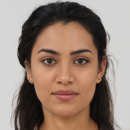 Joyful latino young-adult female with long  brown hair and brown eyes