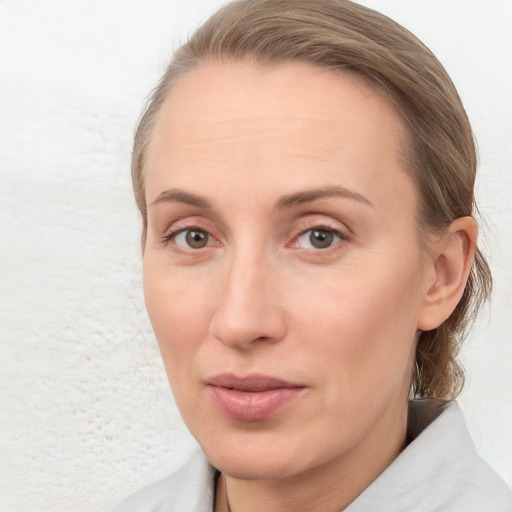 Joyful white young-adult female with medium  brown hair and blue eyes