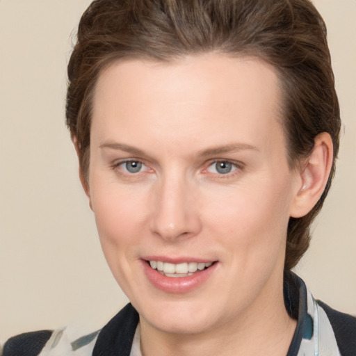 Joyful white young-adult female with short  brown hair and grey eyes