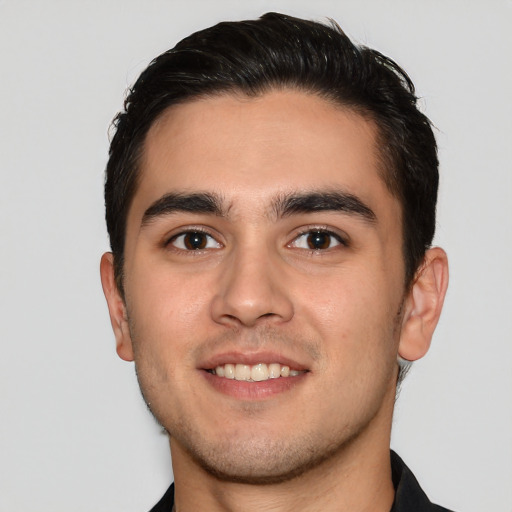 Joyful white young-adult male with short  black hair and brown eyes