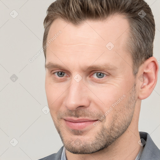 Joyful white adult male with short  brown hair and brown eyes