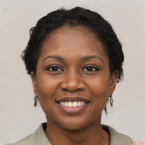 Joyful black young-adult female with short  brown hair and brown eyes