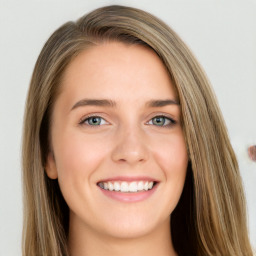 Joyful white young-adult female with long  brown hair and green eyes