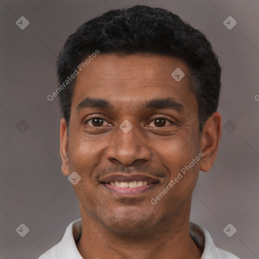 Joyful latino adult male with short  black hair and brown eyes