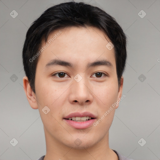 Joyful asian young-adult male with short  brown hair and brown eyes