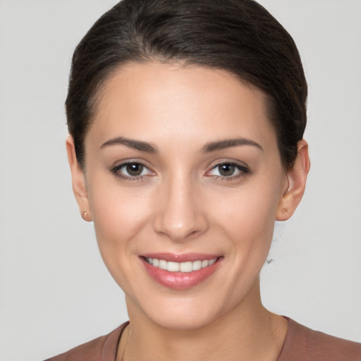 Joyful white young-adult female with short  brown hair and brown eyes