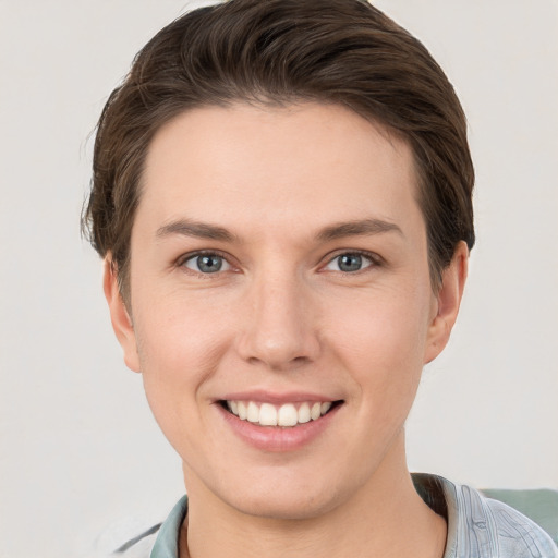 Joyful white young-adult female with short  brown hair and grey eyes