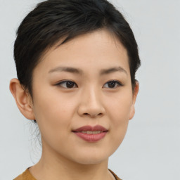 Joyful asian young-adult female with short  brown hair and brown eyes