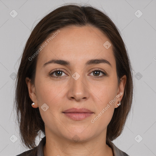 Joyful white adult female with medium  brown hair and brown eyes