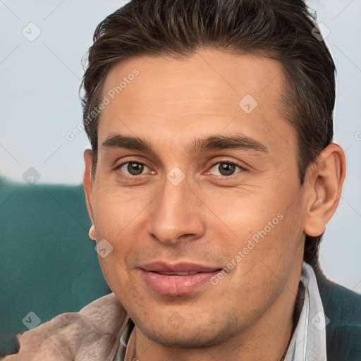 Joyful white adult male with short  brown hair and brown eyes