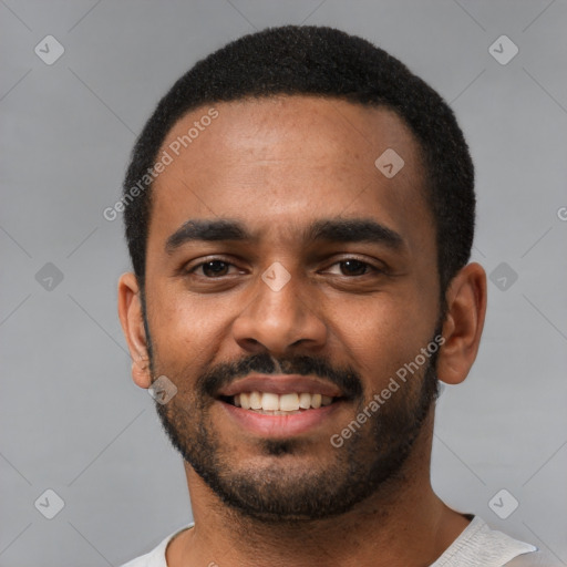 Joyful black young-adult male with short  black hair and brown eyes