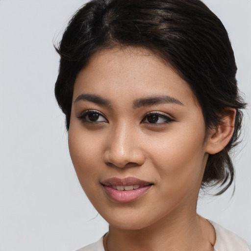 Joyful asian young-adult female with medium  black hair and brown eyes