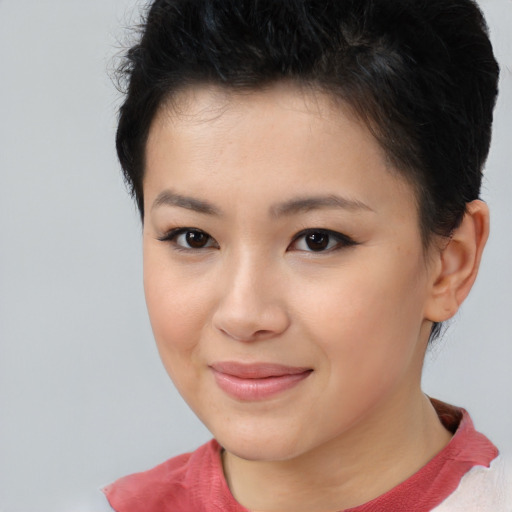 Joyful asian young-adult female with short  brown hair and brown eyes