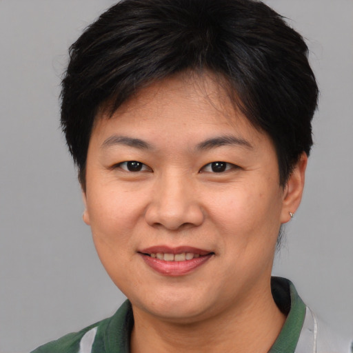 Joyful asian young-adult female with short  brown hair and brown eyes