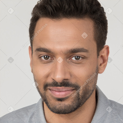 Joyful white young-adult male with short  brown hair and brown eyes