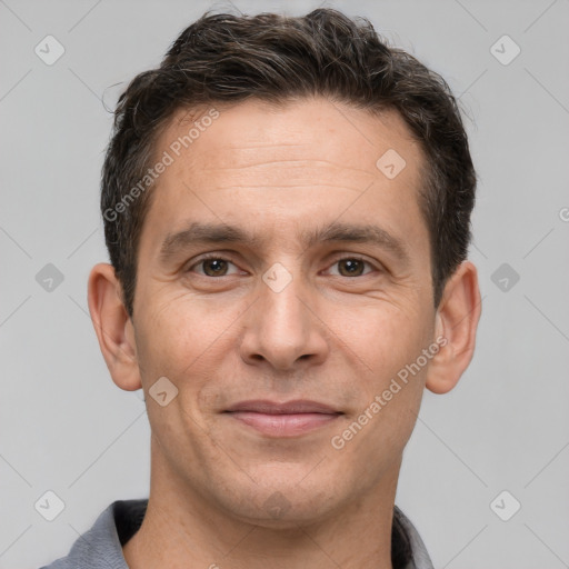 Joyful white adult male with short  brown hair and brown eyes