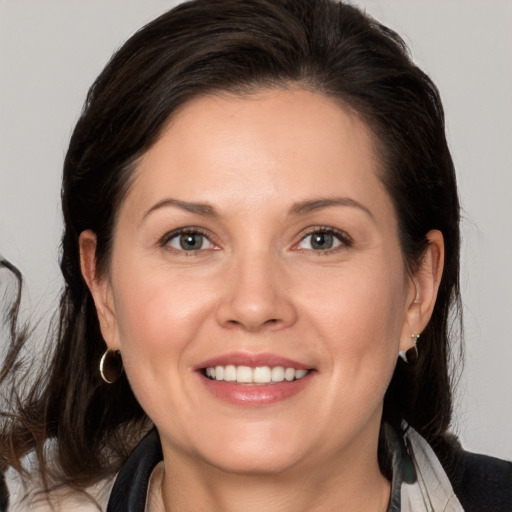 Joyful white adult female with medium  brown hair and brown eyes