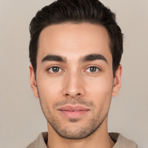 Joyful white young-adult male with short  brown hair and brown eyes