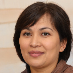 Joyful white adult female with medium  brown hair and brown eyes