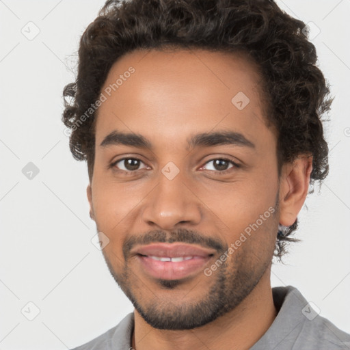 Joyful black young-adult male with short  brown hair and brown eyes