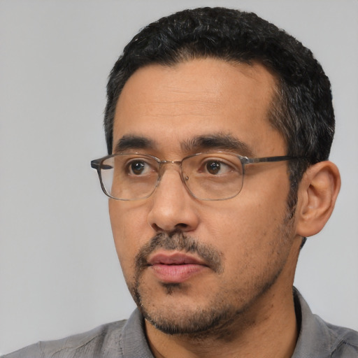Neutral latino adult male with short  black hair and brown eyes