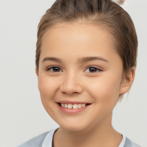 Joyful white child female with short  brown hair and brown eyes