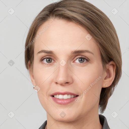 Joyful white young-adult female with medium  brown hair and grey eyes