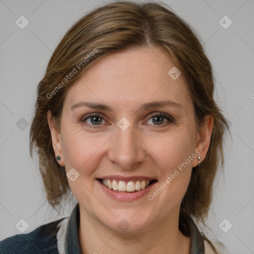 Joyful white adult female with medium  brown hair and grey eyes