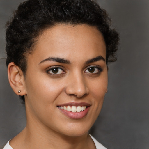 Joyful latino young-adult female with short  brown hair and brown eyes