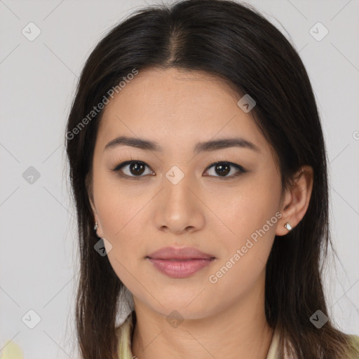 Joyful latino young-adult female with long  brown hair and brown eyes