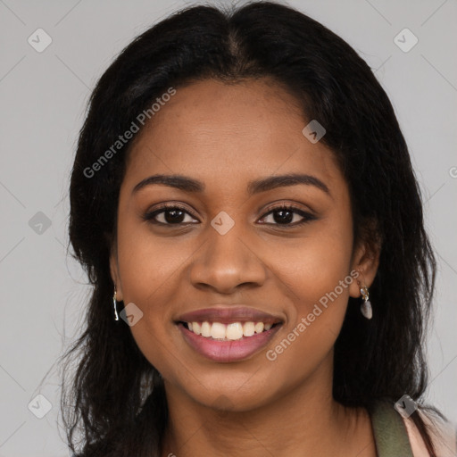 Joyful black young-adult female with long  brown hair and brown eyes