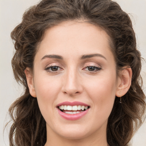 Joyful white young-adult female with long  brown hair and green eyes