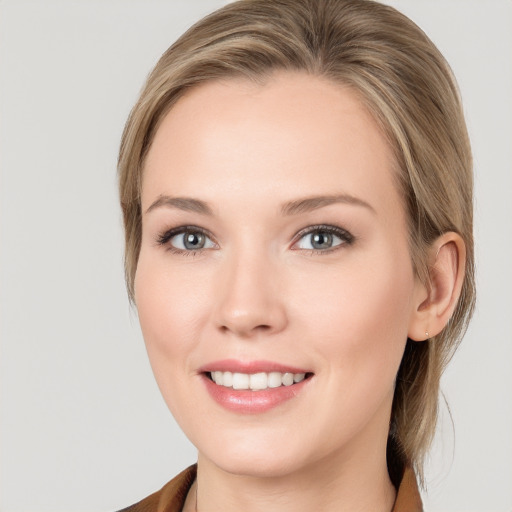 Joyful white young-adult female with medium  brown hair and blue eyes