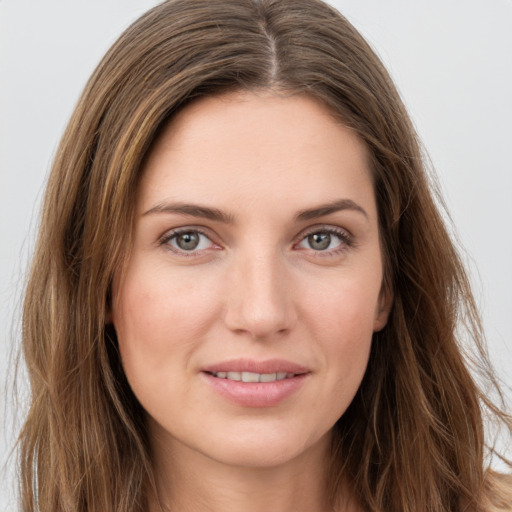 Joyful white young-adult female with long  brown hair and green eyes