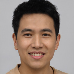 Joyful asian young-adult male with short  black hair and brown eyes