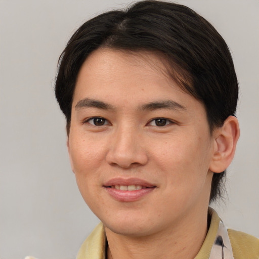Joyful asian young-adult female with medium  brown hair and brown eyes
