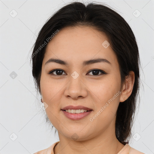 Joyful latino young-adult female with medium  brown hair and brown eyes