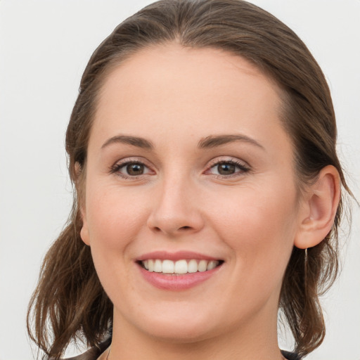 Joyful white young-adult female with long  brown hair and grey eyes