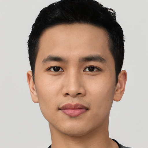 Joyful asian young-adult male with short  black hair and brown eyes