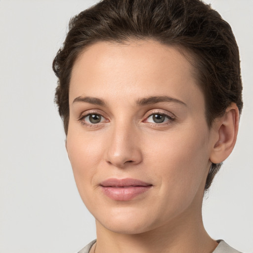 Joyful white young-adult female with short  brown hair and grey eyes