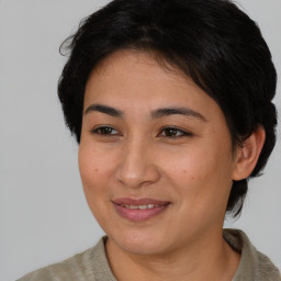 Joyful asian young-adult female with short  brown hair and brown eyes