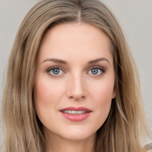 Joyful white young-adult female with long  brown hair and grey eyes