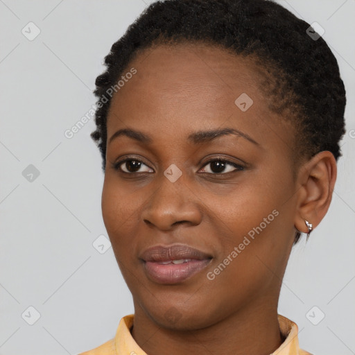 Joyful black young-adult female with short  black hair and brown eyes