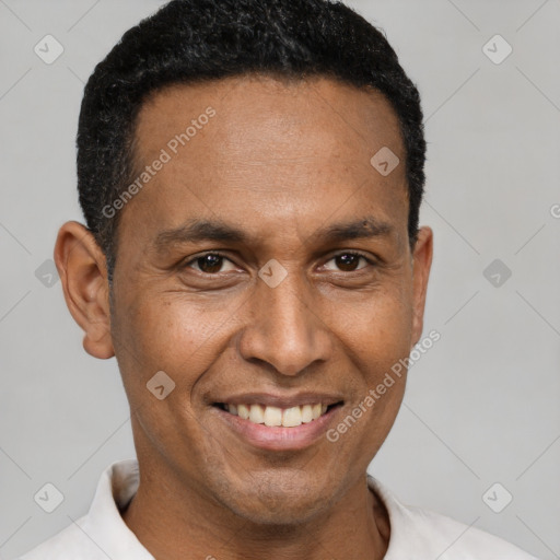 Joyful latino adult male with short  black hair and brown eyes