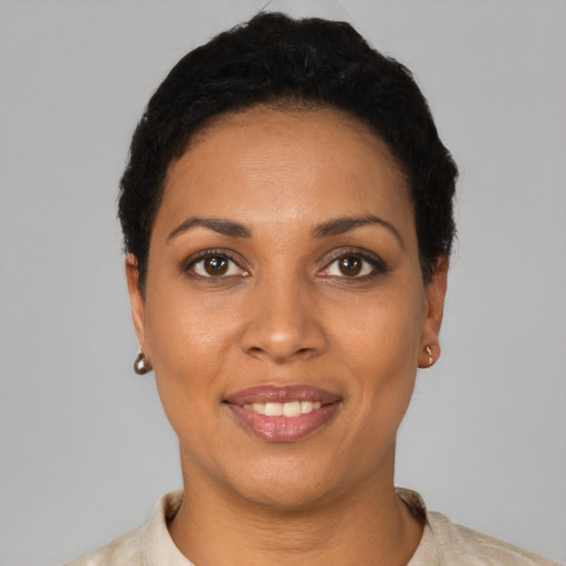 Joyful black young-adult female with short  black hair and brown eyes