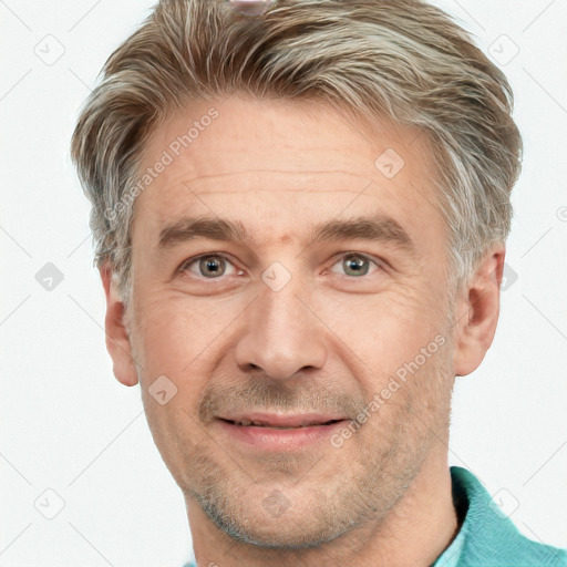 Joyful white adult male with short  brown hair and grey eyes