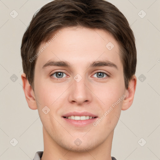 Joyful white young-adult male with short  brown hair and grey eyes