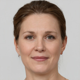 Joyful white adult female with short  brown hair and grey eyes