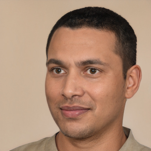 Joyful white young-adult male with short  black hair and brown eyes