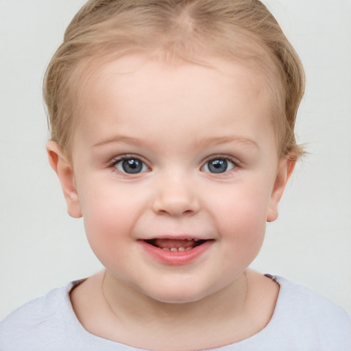 Joyful white child female with short  blond hair and blue eyes